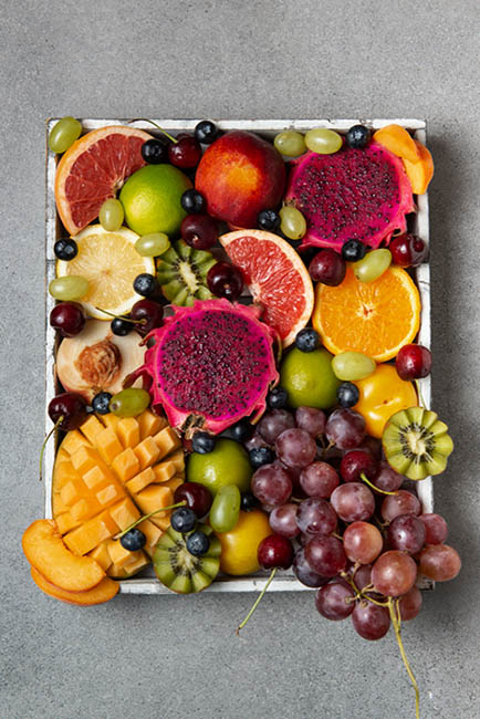 12-exotic-fruit-tray-delicious-fruits-kiwi-mango-grapes-orange-blueberry-grapefruit-cherry-apple-tray-top-view
